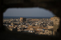 A tent camp for displaced Palestinians stretches amid the ruins of destroyed buildings in Khan Younis, in the southern Gaza Strip, Saturday, Nov. 8, 2025. (AP Photo/Abdel Kareem Hana)