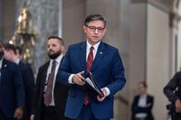 Speaker of the House Mike Johnson, R-La., walks from the chamber to speak with reporters after the final vote to bring the longest government shutdown in history to an end, at the Capitol in Washington, Wednesday, Nov. 12, 2025. (AP Photo/J. Scott Applewhite)