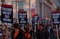 Protesters march past the Milken Center for Advancing the American Dream, during a "Trump Must Go Now!" rally by the White House, Monday, Nov. 17, 2025, in Washington. (AP Photo/Jacquelyn Martin)