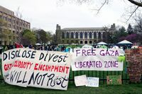 FILE - Signs are displayed outside a tent encampment at Northwestern University on April 26, 2024, in Evanston, Illinois. (AP Photo/Teresa Crawford, file)
