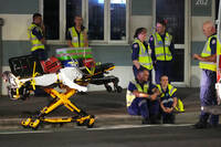 Emergency workers transport a person on a stretcher after a reported shooting at Bondi Beach in Sydney, Sunday, Dec. 14, 2025. (AP Photo/Mark Baker)