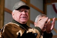 FILE - Minnesota Gov. Tim Walz applauds as President Joe Biden speaks at Dutch Creek Farms in Northfield, Minn., Nov. 1, 2023. (AP Photo/Andrew Harnik, File)