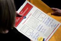 FILE - Staff members hold the certification of Electoral College votes from Tennessee during a joint session of the House and Senate to confirm Electoral College votes at the Capitol, early Jan 7, 2021, in Washington. (AP Photo/Andrew Harnik, File)