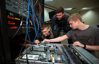 UW-Stout students work on a computer server in a lab.