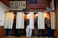 Voters mark their ballots at a polling place, Tuesday, Nov. 5, 2024, in Mitchell, Wis. (AP Photo/Morry Gash)