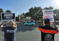 FILE - Supporters of democratic presidential nominee Vice President Kamala Harris and Republican presidential nominee former President Donald Trump campaign outside a polling place, Nov. 5, 2024, in McAllen, Texas.(Joel Martinez/The Monitor via AP, File)/The Monitor via AP)