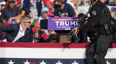 Republican presidential candidate former President Donald Trump is surrounded by U.S. Secret Service at a campaign event in Butler, Pa., on Saturday, July 13, 2024. (AP Photo/Gene J. Puskar)