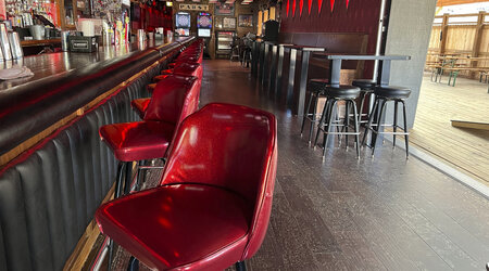 Stools line the bar at Elwood's Liquor and Tap on Thursday, July 18, 2024 in Milwaukee, Wis. This week's Republican National Convention didn't deliver an overwhelming victory to some small businesses in downtown Milwaukee. There had been earlier promises of an economic boost, but some bars, convenience stores and restaurants along the edge of the secure zone sat largely empty all week. (AP Photo/Patrick Orsagos)