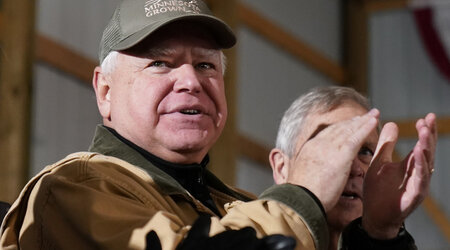 FILE - Minnesota Gov. Tim Walz applauds as President Joe Biden speaks at Dutch Creek Farms in Northfield, Minn., Nov. 1, 2023. (AP Photo/Andrew Harnik, File)