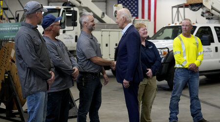 President Joe Biden, third from right, greets workers from Dairyland Power Cooperative and Vernon Electric Cooperative during a visit to Vernon Electric in Westby, Wis., Thursday, Sept. 5, 2024. Biden is in Wisconsin to promote his Investing in America agenda. (AP Photo/Susan Walsh)