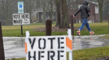 FILE - A voter braves a cold rain running to cast a ballot during the Spring election, April 2, 2024, in Fox Point, Wis. (AP Photo/Morry Gash, File)