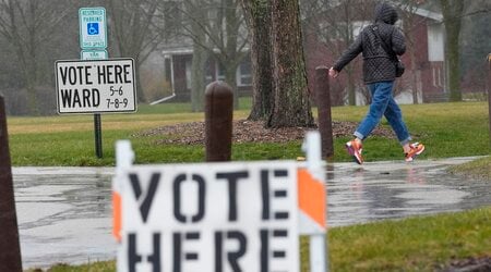 FILE - A voter braves a cold rain running to cast a ballot during the Spring election, April 2, 2024, in Fox Point, Wis. (AP Photo/Morry Gash, File)