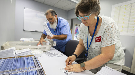 FILE - Dawn Stephens, right, and Duane Taylor prepare ballots to be mailed at the Mecklenburg County Board of Elections in Charlotte, N.C., Sept. 5, 2024. (AP Photo/Nell Redmond)