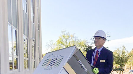 n this photo provided by Wausau Mayor Doug Diny, Diny uses a dolly to remove the city's lone drop box from in front of City Hall in Wausau, Wis., on Sunday, Sept. 22, 2024. (Doug Diny via AP)