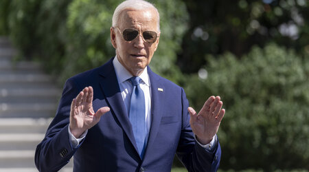 President Joe Biden gestures to the media as he walks to Marine One on the South Lawn of the White House in Washington, Saturday, Oct. 5, 2024. (AP Photo/Ben Curtis)