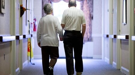 FILE - An elderly couple walks down a hall on Nov. 6, 2015 in Easton, Pa. (AP Photo/Matt Rourke, File)