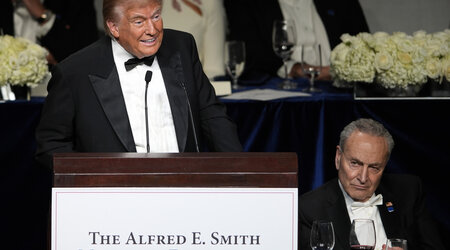 Republican presidential nominee former President Donald Trump speaks as Senate Majority Leader Chuck Schumer of N.Y., listens at the 79th annual Alfred E. Smith Memorial Foundation Dinner, Thursday, Oct. 17, 2024, in New York. (AP Photo/Julia Demaree Nikhinson)