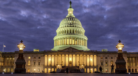 FILE - Lights shine inside the U.S. Capitol Building as night falls on Jan. 21, 2018, in Washington. (AP Photo/J. David Ake, File)