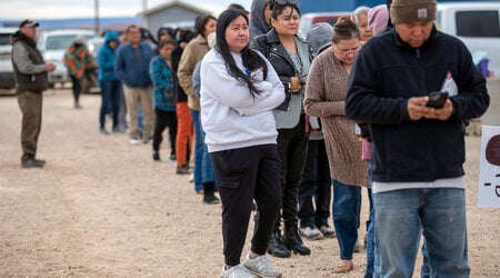 Voters wait in line to cast their ballots outside a polling station on the Navajo Nation in Chinle, Ariz., on Election Day, Tuesday, Nov. 5, 2024. (AP Photo/Andres Leighton)