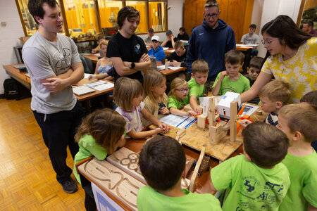 The mechanical engineering team shows its manufacturing cell to the kindergartners.