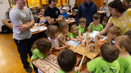 The mechanical engineering team shows its manufacturing cell to the kindergartners.