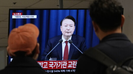 FILE - People watch a TV screen showing South Korean President Yoon Suk Yeol's televised briefing at a bus terminal in Seoul, South Korea, Dec. 3, 2024. (AP Photo/Ahn Young-joon, File)