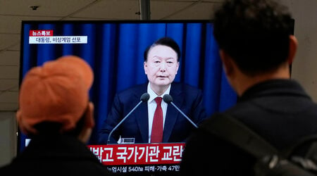 FILE - People watch a TV screen showing South Korean President Yoon Suk Yeol's televised briefing at a bus terminal in Seoul, South Korea, Dec. 3, 2024. (AP Photo/Ahn Young-joon, File)