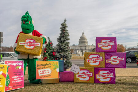 FILE - In advance of Instagram CEO Adam Mosseri's Congressional testimony, to illustrate the harms children face on social media, parent activists brought an &quot;Instagrinch&quot; to the Capitol building in Washington, Dec. 7, 2021. (Eric Kayne/AP Images for ParentsTogether, File)