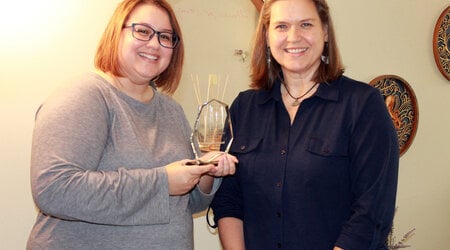 UW-Stout marriage and family therapy Assistant Professor Heather Hessel (right) receives her Carl Whitaker Award from WAMFT Chairperson Amanda Anderson (left). Photo contributed by Amanda Anderson.