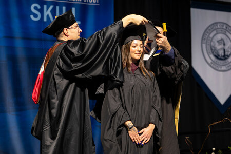 Inspiring graduate Hailey Kollmansberger receives her master’s hood. She earned her M.S. Ed. in school psychology from UW-Stout.