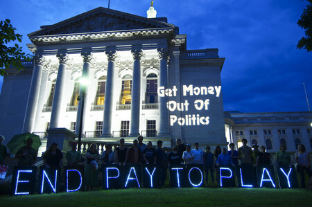 Madison capitol with Get Money Out of Politics projected on it