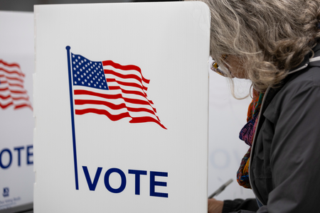 A voter casts a ballot on Election Day on Nov. 5, 2024, at Madison East High School in Madison, Wis. (Joe Timmerman / Wisconsin Watch)