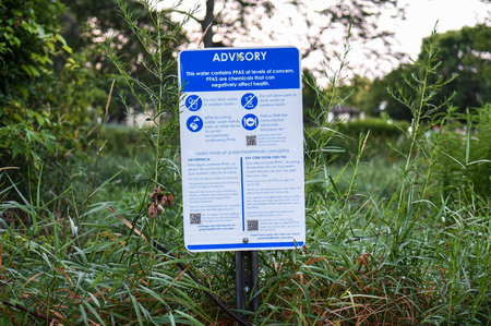 A sign warning of PFAS risks in Starkweather Creek in Madison, Wis., is posted along the creek on July 20, 2021. Wisconsin Gov. Tony Evers is now proposing more funding to clean up toxic “forever chemicals” known as PFAS. (Isaac Wasserman / Wisconsin Watch)