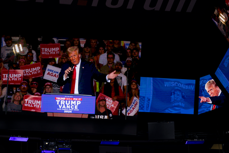 A jumbotron displays President Donald Trump addressing the crowd during his final rally in Wisconsin, just days before the general election, on Nov. 1, 2024, at Fiserv Forum in Milwaukee. (Joe Timmerman / Wisconsin Watch)