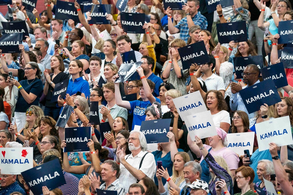 Supports hold up signs in support of Vice President Kamala Harris as she campaigns for President as the presumptive Democratic candidate during an event at West Allis Central High School on Tuesday, July 23, 2024, in West Allis, Wis. (AP Photo/Kayla Wolf)