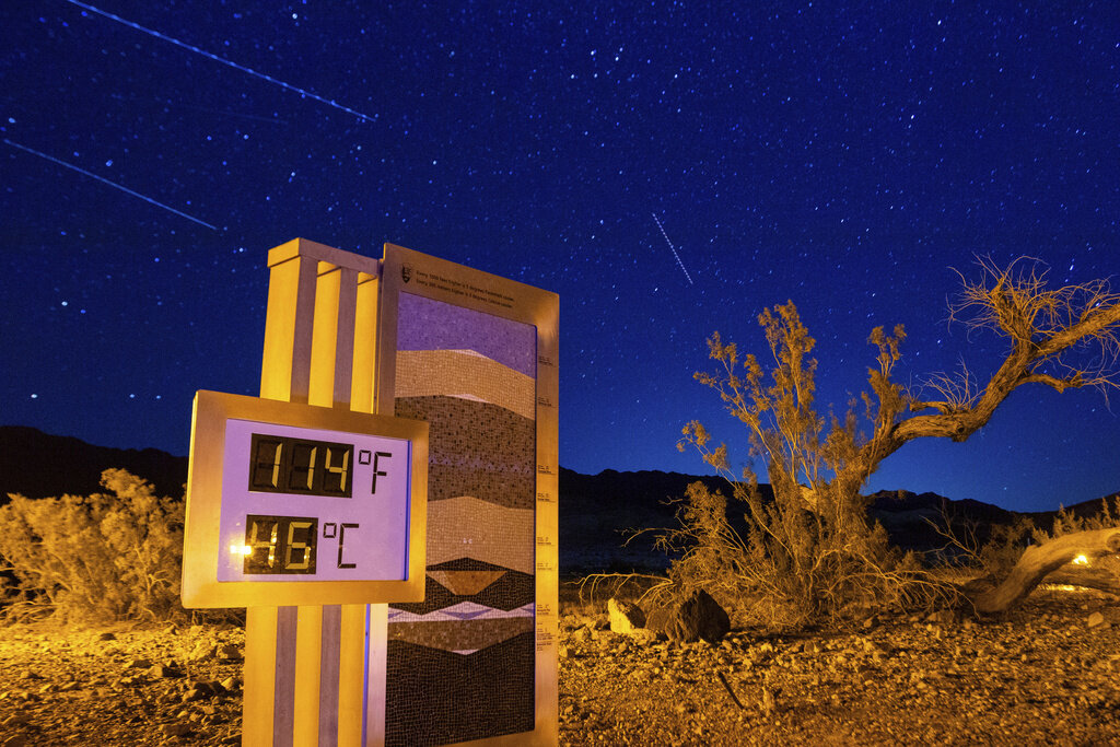 FILE - A long exposure image shows the recorded temperature on a thermostat at the Furnace Creek Visitors Center, after 10:00 p.m. July 7, 2024, in Death Valley National Park, Calif. (AP Photo/Ty ONeil, File)