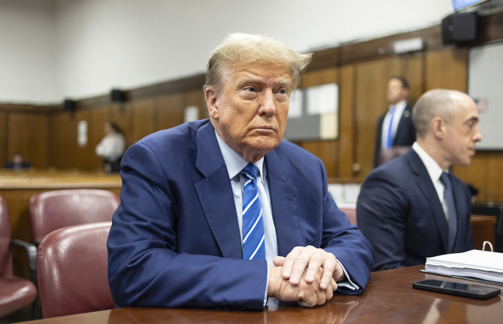 FILE - Former President Donald Trump awaits the start of proceedings on the second day of jury selection at Manhattan criminal court, April 16, 2024, in New York. Manhattan prosecutors are balking at Donald Trump efforts to delay post-trial decisions in his New York hush money criminal case as he seeks to have a federal court intervene and potentially overturn his felony conviction. They lodged their objections in a letter Tuesday to the trial judge but said they could be OK with postponing the ex-president