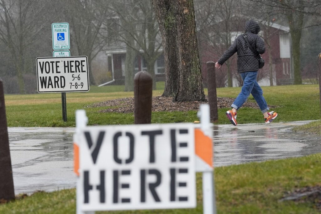 FILE - A voter braves a cold rain running to cast a ballot during the Spring election, April 2, 2024, in Fox Point, Wis. (AP Photo/Morry Gash, File)