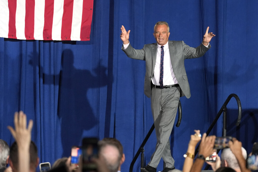 Former Independent candidate for president Robert F. Kennedy, Jr. waves to the crowd as he arrives on stage prior to speaking at a campaign event for Republican presidential nominee former President Donald Trump, Saturday, Sept. 14, 2024, in Glendale, Ariz. (AP Photo/Ross D. Franklin)