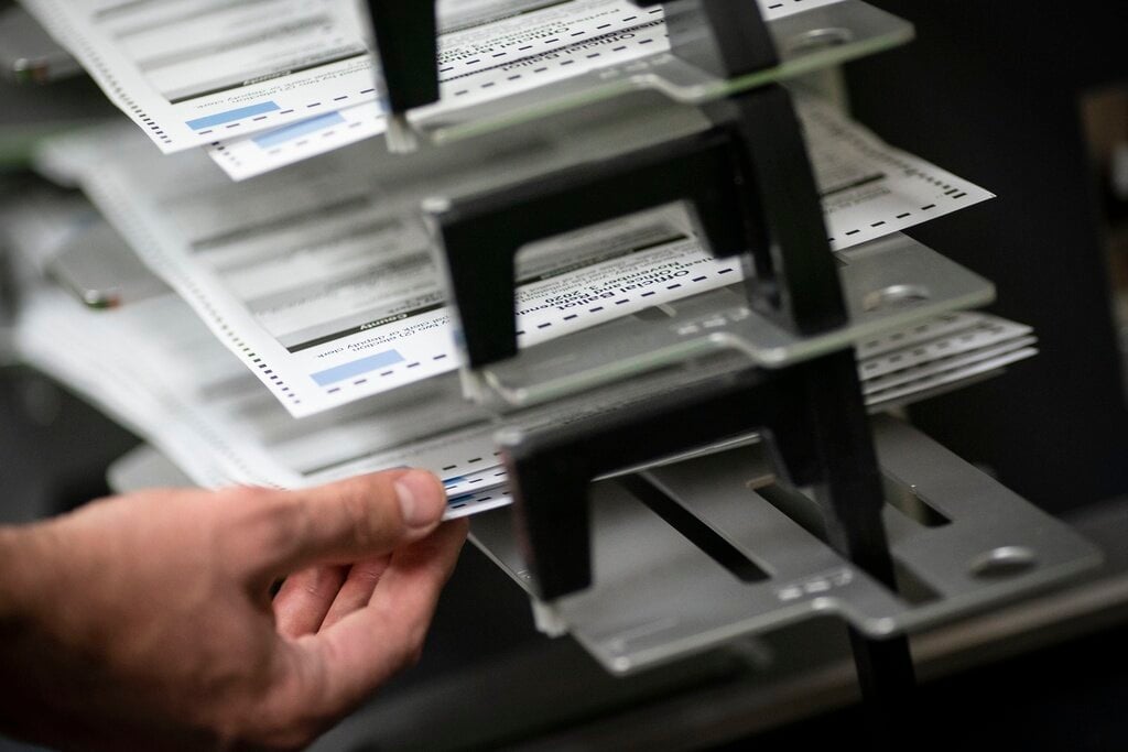 FILE - Poll workers sort out early and absentee ballots at the Kenosha Municipal building on Election Day, in Kenosha, Wis., Nov. 3, 2020. (AP Photo/Wong Maye-E, File)