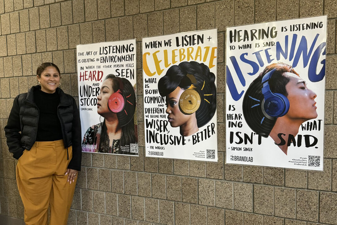 BrandLab’s National Director Michaela Clubb with Kate Gillette's poster series. Photo contributed by Michaela Clubb