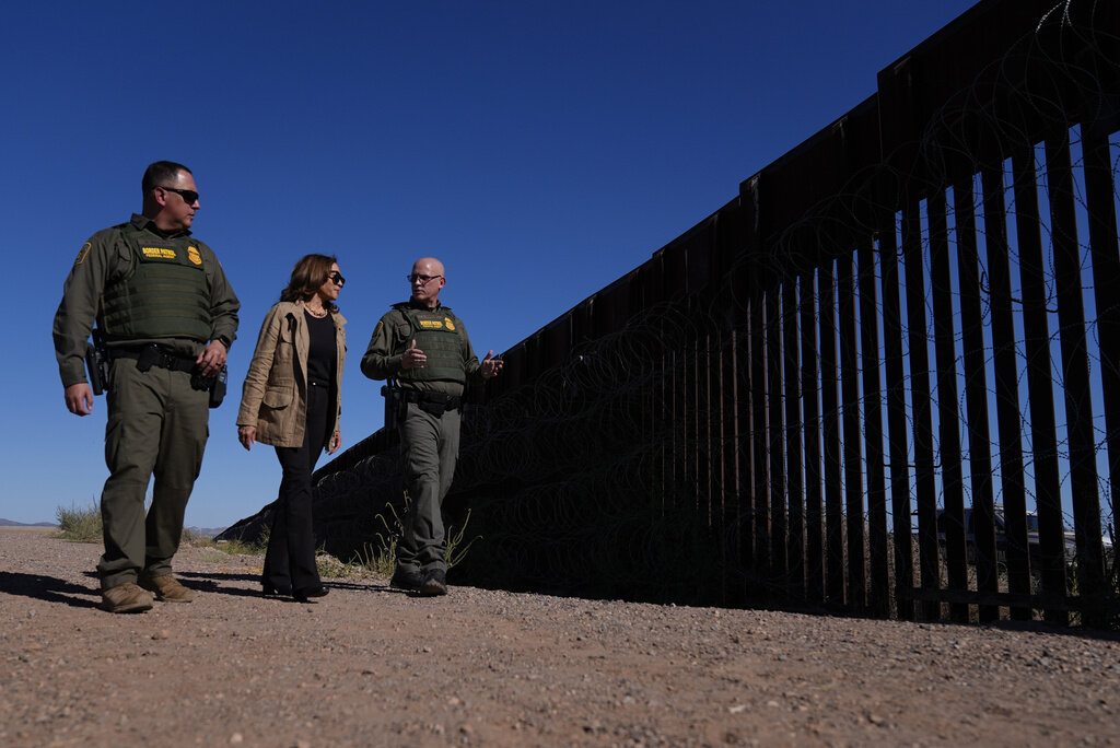 Democratic presidential nominee Vice President Kamala Harris talks with John Modlin, the chief patrol agent for the Tucson Sector of the U.S. Border Patrol, right, and Blaine Bennett, the U.S. Border Patrol Douglas Station border patrol agent in charge, as she visits the U.S. border with Mexico in Douglas, Ariz., Friday, Sept. 27, 2024. (AP Photo/Carolyn Kaster)