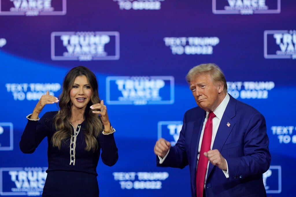 Republican presidential nominee former President Donald Trump and South Dakota Gov. Kristi Noem dance to the song &quot;Y.M.C.A.&quot; at a campaign town hall at the Greater Philadelphia Expo Center &amp; Fairgrounds, Monday, Oct. 14, 2024, in Oaks, Pa. (AP Photo/Matt Rourke)