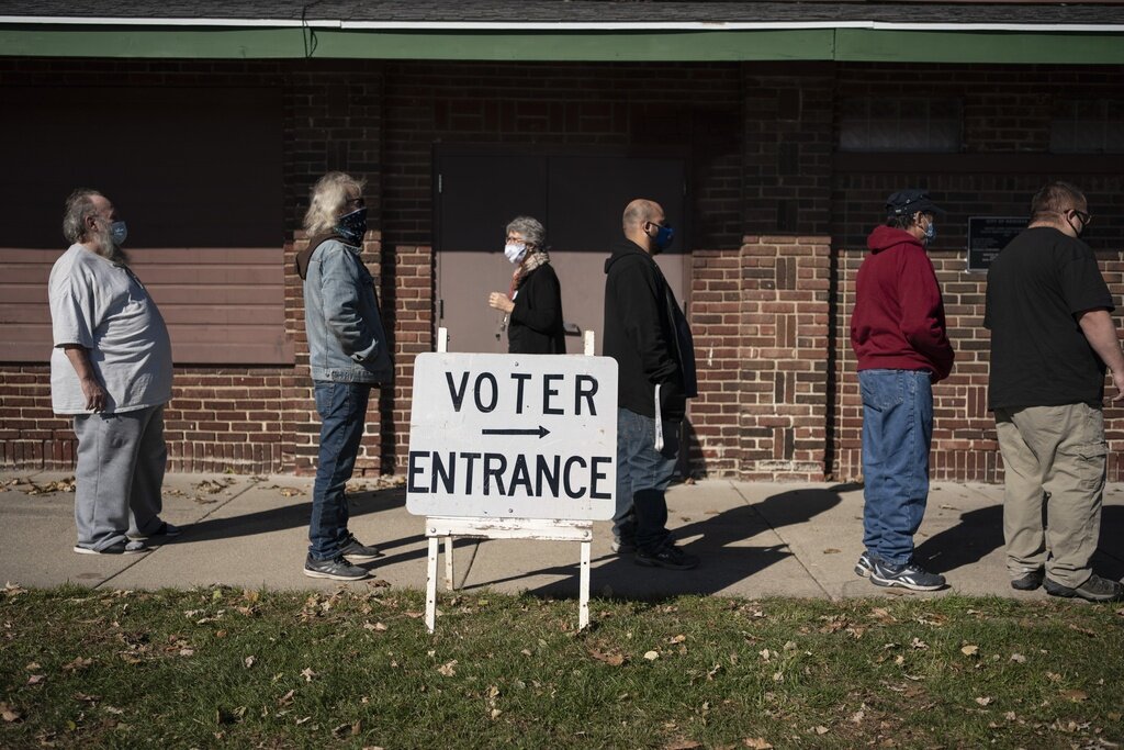 FILE - In this Tuesday, Nov. 3, 2020, file photo, voters wait in line outside a polling center on Election Day, in Kenosha, Wis. (AP Photo/Wong Maye-E, File