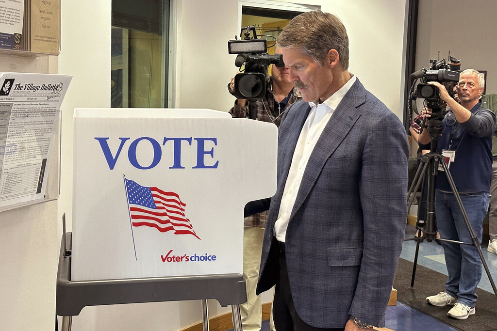 Republican U.S. Senate candidate Eric Hovde casts his ballot at the Village Hall in Shorewood Hills, Wis., Tuesday, Oct. 22, 2024, the first day of early in-person absentee voting in the battleground state. (AP Photo/Todd Richmond)