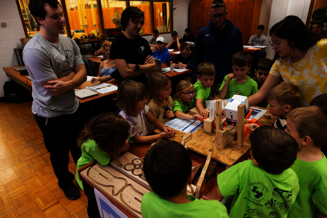 The mechanical engineering team shows its manufacturing cell to the kindergartners.