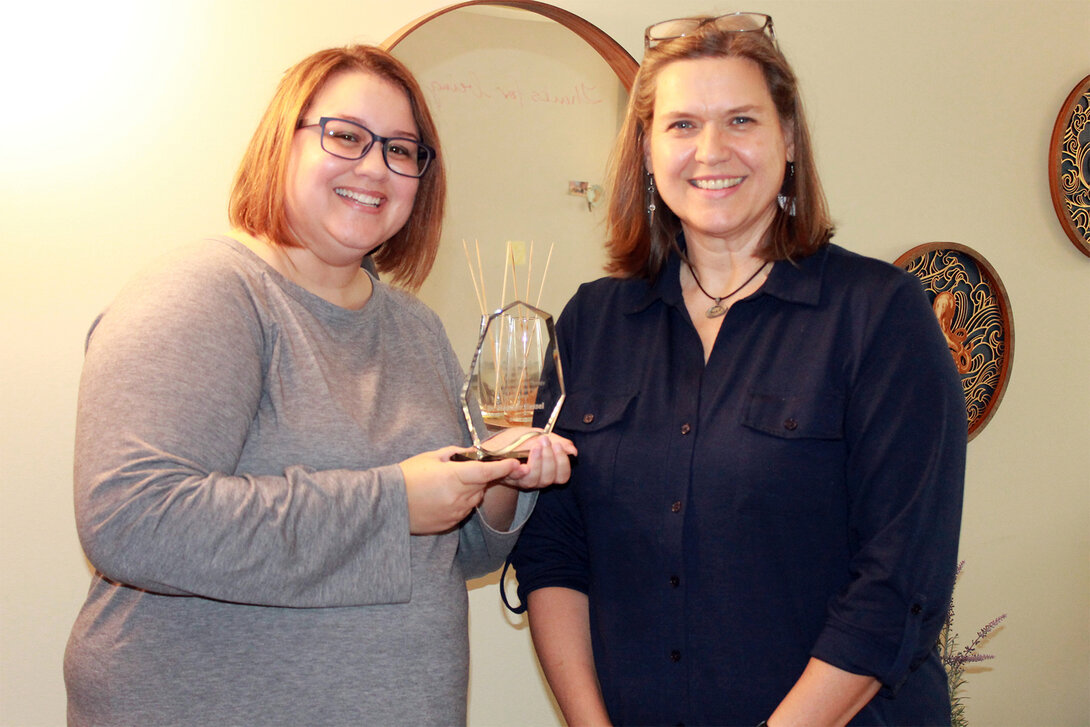 UW-Stout marriage and family therapy Assistant Professor Heather Hessel (right) receives her Carl Whitaker Award from WAMFT Chairperson Amanda Anderson (left). Photo contributed by Amanda Anderson.